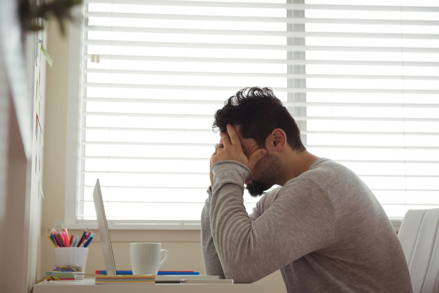 stressed-man-sitting-with-hands-head