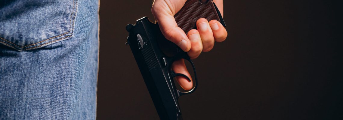 handsome-man-actor-posing-studio-with-weapon-1