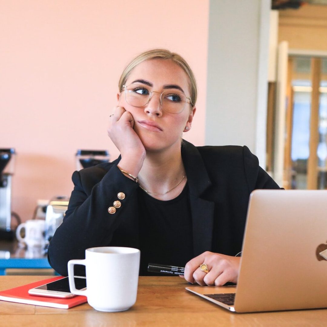 woman in black long sleeve shirt using macbook